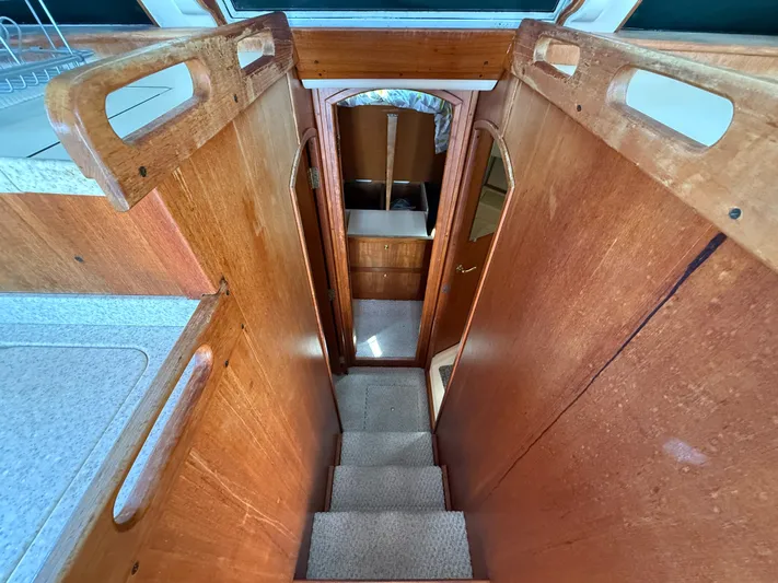 Real Therapy Yacht Photos Pics Interior view of 2001 Mainship 390 Trawler, featuring wooden stairs and cabin entrance.