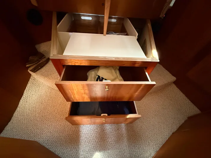 Real Therapy Yacht Photos Pics Wooden drawers in a 2001 Mainship 390 Trawler, showcasing interior storage space.