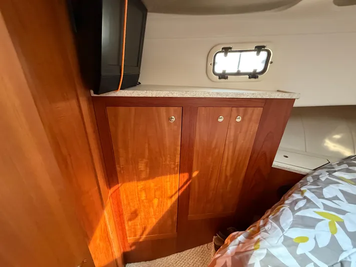 Real Therapy Yacht Photos Pics Interior of 2001 Mainship 390 Trawler with wooden cabinet and small window.