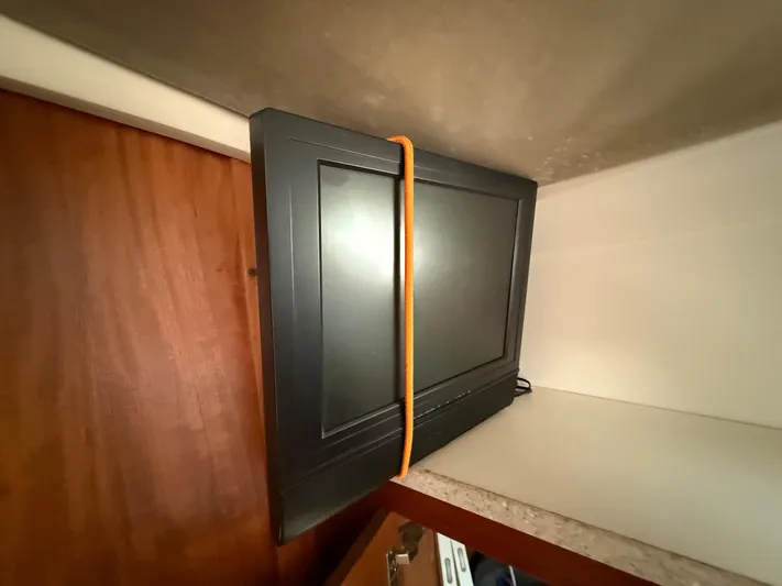 Real Therapy Yacht Photos Pics TV secured with orange strap inside 2001 Mainship 390 Trawler cabin.