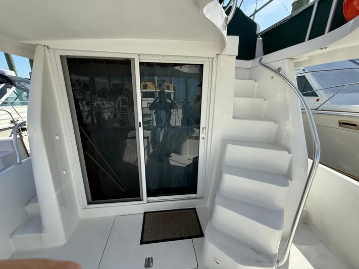 Real Therapy Yacht Photos Pics 2001 Mainship 390 Trawler with white stairs and sliding glass door.