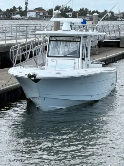  Yacht Photos Pics 2018 Robalo R302 Center Console boat docked by the waterfront.