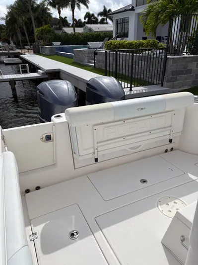  Yacht Photos Pics 2018 Robalo R302 Center Console boat with dual engines docked by a waterfront property.