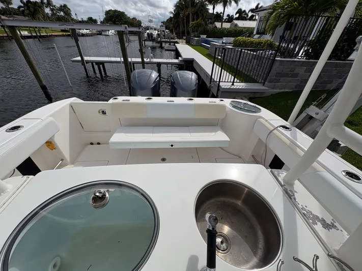  Yacht Photos Pics 2018 Robalo R302 Center Console boat with dual engines and seating area.