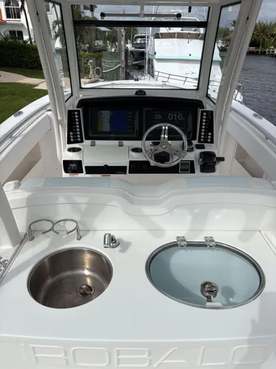  Yacht Photos Pics 2018 Robalo R302 Center Console boat interior with steering wheel and sink.