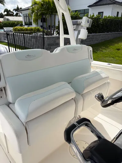  Yacht Photos Pics 2018 Robalo R302 Center Console boat with white seating and steering wheel.