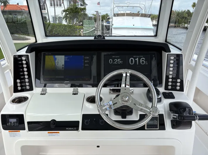  Yacht Photos Pics 2018 Robalo R302 Center Console boat dashboard with steering wheel and navigation displays.