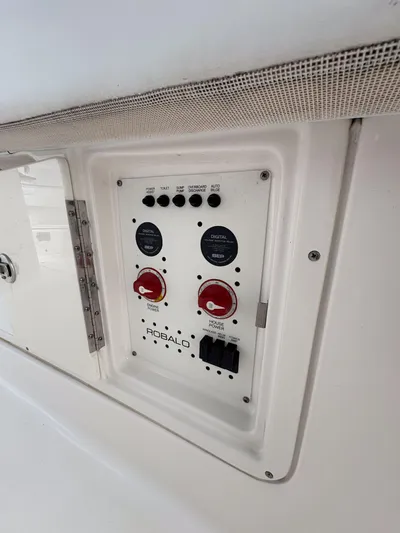  Yacht Photos Pics Control panel of 2018 Robalo R302 Center Console boat, featuring switches and dials.