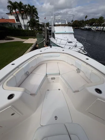  Yacht Photos Pics 2018 Robalo R302 Center Console boat docked, featuring spacious seating and sleek design.