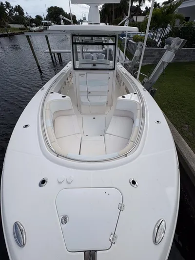  Yacht Photos Pics 2018 Robalo R302 Center Console boat docked by a canal.