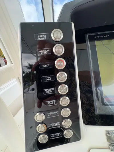  Yacht Photos Pics Control panel of 2018 Robalo R302 Center Console boat with various switches and buttons.