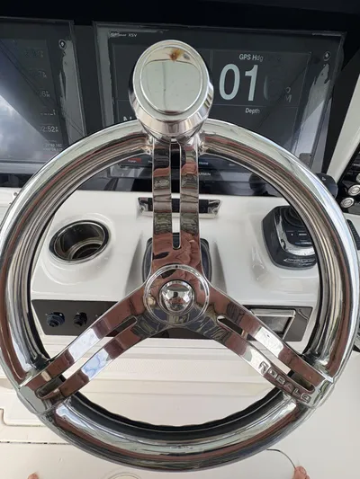  Yacht Photos Pics Steering wheel of 2018 Robalo R302 Center Console boat with GPS display.
