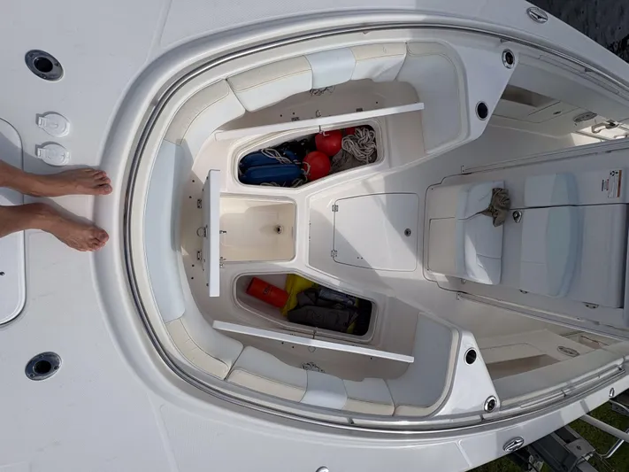  Yacht Photos Pics 2018 Robalo R302 Center Console boat interior with storage compartments and seating.