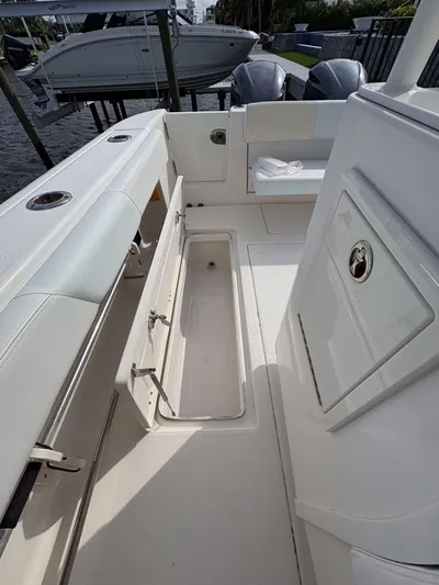  Yacht Photos Pics 2018 Robalo R302 Center Console boat interior with storage compartment and seating.