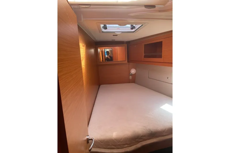  Yacht Photos Pics 2022 Dufour 530 yacht cabin with wooden interior and skylight.