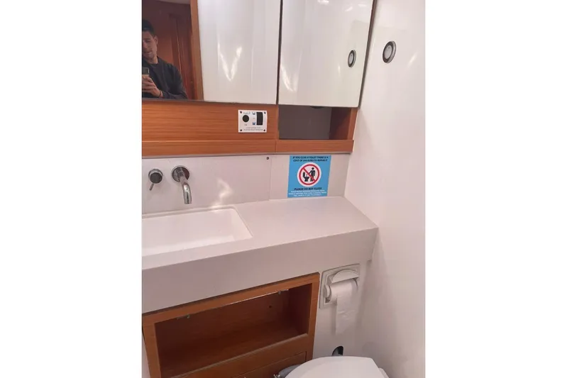  Yacht Photos Pics Bathroom interior of 2022 Dufour 530 yacht with sink, mirror, and storage.