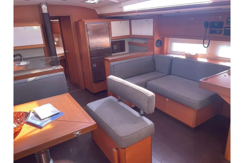  Yacht Photos Pics Modern interior of 2022 Dufour 530 yacht with cozy seating and wooden finishes.