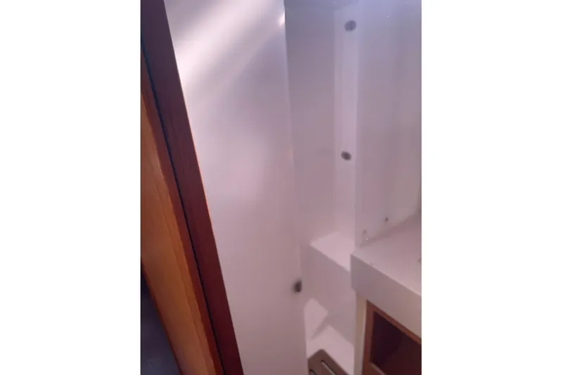  Yacht Photos Pics Interior view of 2022 Dufour 530 yacht, showcasing sleek white cabinetry.