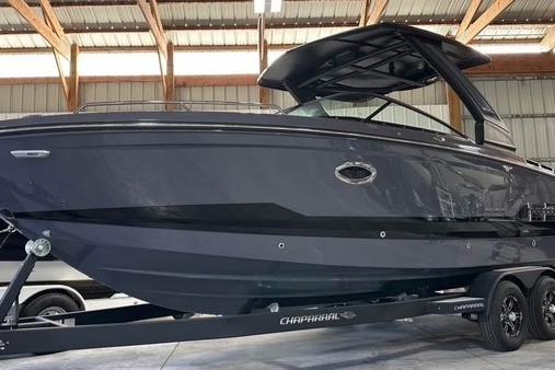 2025 Chaparral 2870 SSX boat in a warehouse, sleek design, on a trailer.