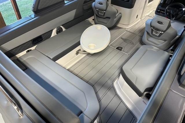 2025 Chaparral 2870 SSX boat interior with gray seating and a round table.