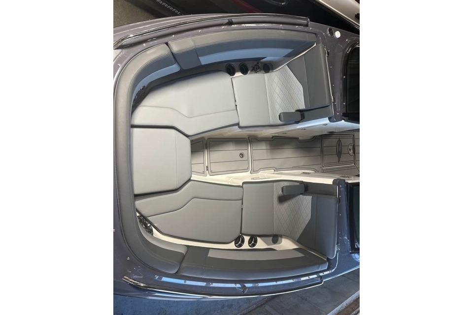 2025 Chaparral 2870 SSX boat interior with gray seating and spacious layout.