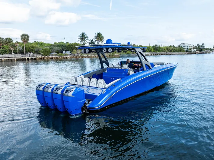  Yacht Photos Pics 2020 Midnight Express Open boat with multiple engines on a calm waterway.