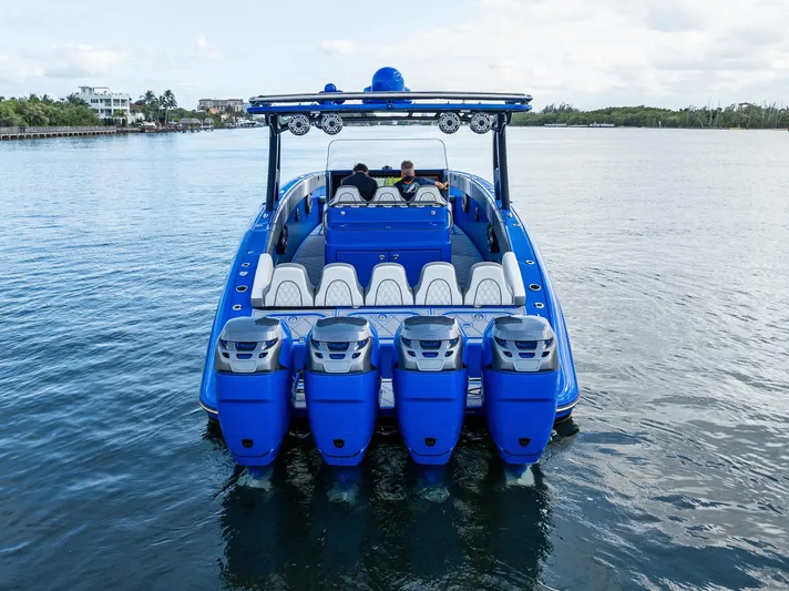  Yacht Photos Pics 2020 Midnight Express Open boat with five powerful outboard engines on a calm waterway.