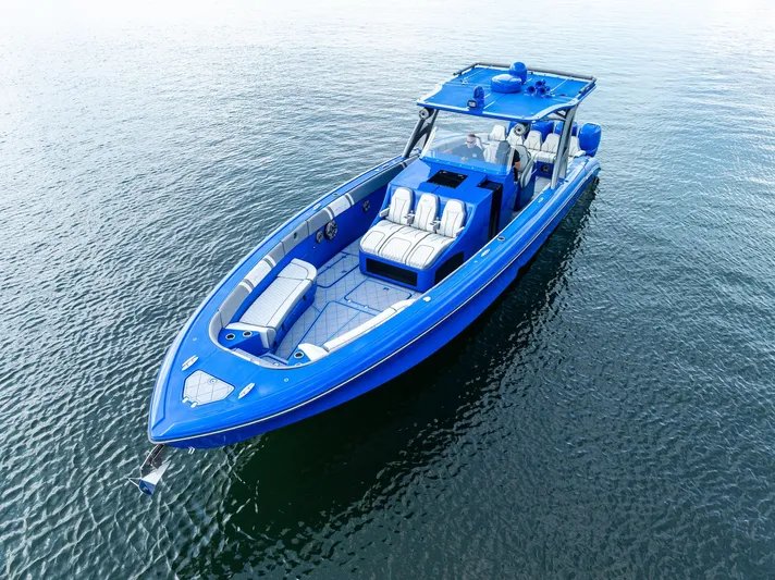  Yacht Photos Pics 2020 Midnight Express Open boat in vibrant blue on calm water.