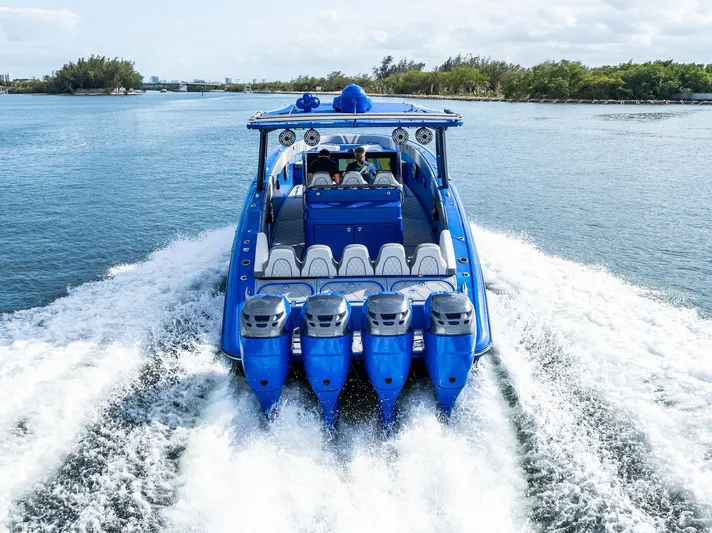  Yacht Photos Pics 2020 Midnight Express Open boat with four engines cruising on a sunny day.