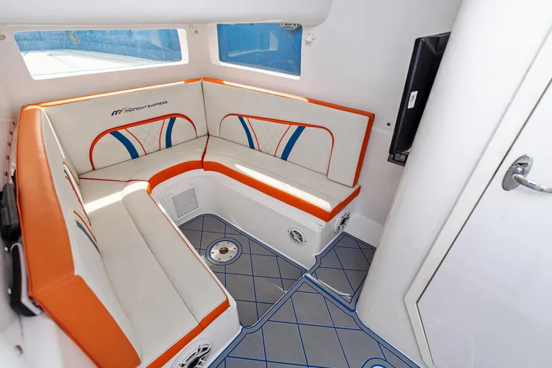  Yacht Photos Pics 2020 Midnight Express Open boat interior with orange and white seating, modern design.