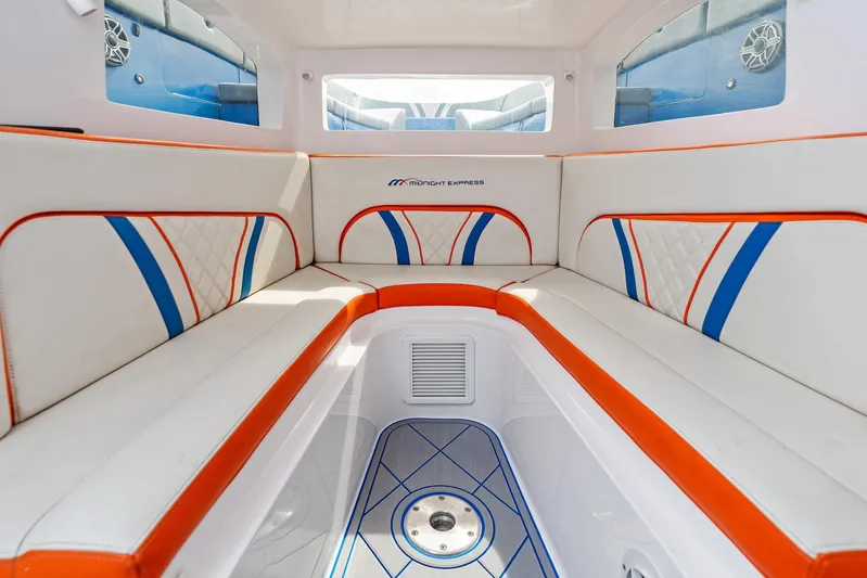  Yacht Photos Pics 2020 Midnight Express Open boat interior with white, orange, and blue seating.