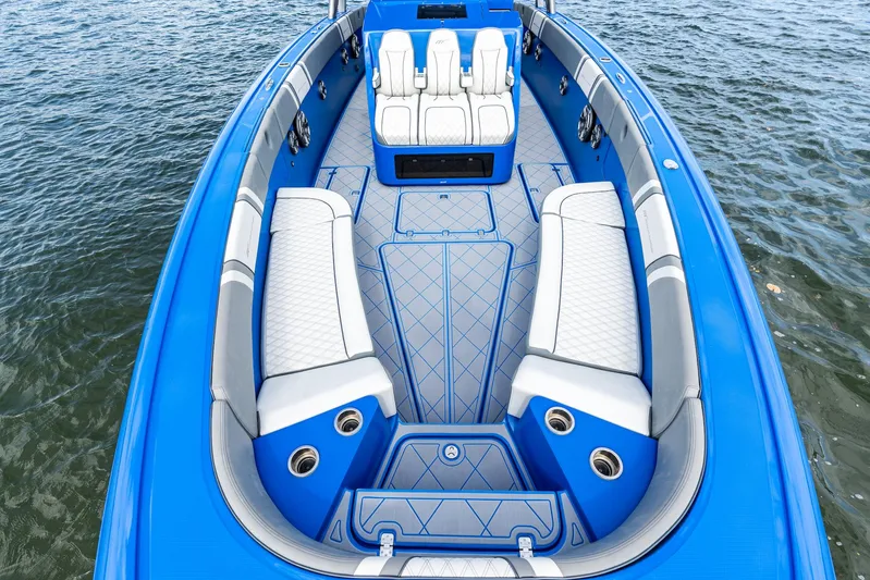  Yacht Photos Pics 2020 Midnight Express Open boat with blue and white seating, on water.