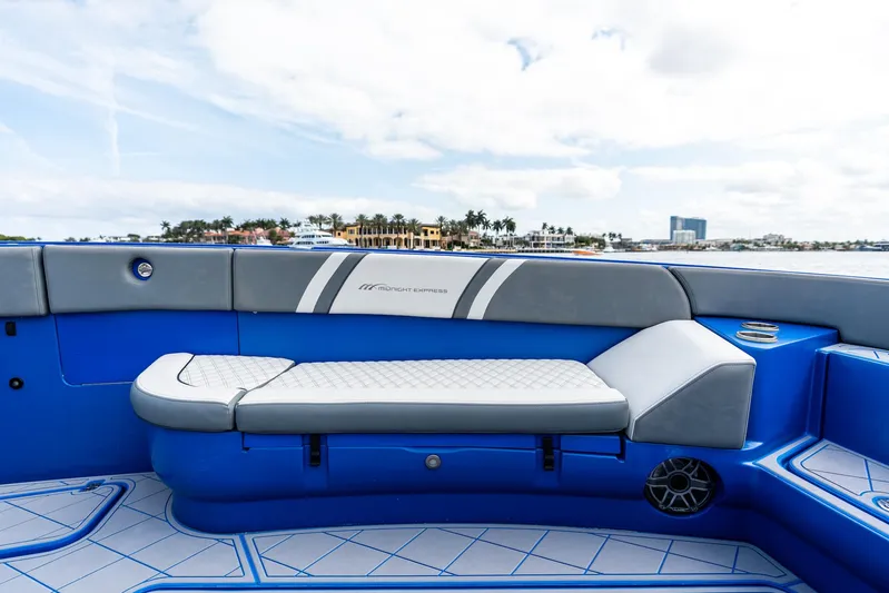  Yacht Photos Pics 2020 Midnight Express Open boat interior with blue and gray seating, coastal view.