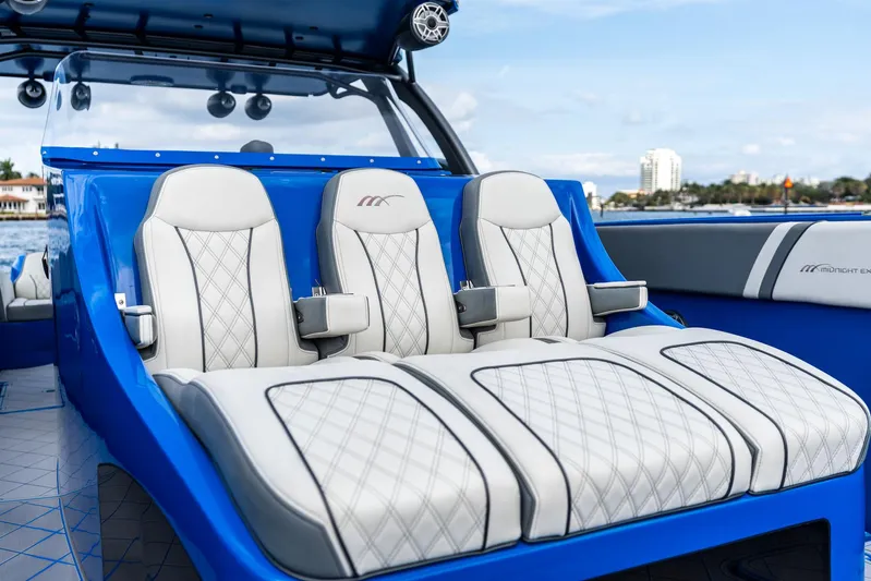  Yacht Photos Pics Luxurious seating on a 2020 Midnight Express Open boat, featuring elegant white and blue design.