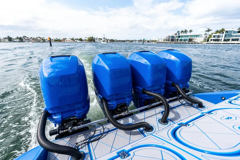  Yacht Photos Pics Four blue outboard motors on a 2020 Midnight Express Open boat in open water.