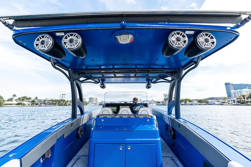  Yacht Photos Pics 2020 Midnight Express Open boat with blue interior and speakers, cruising on a sunny day.