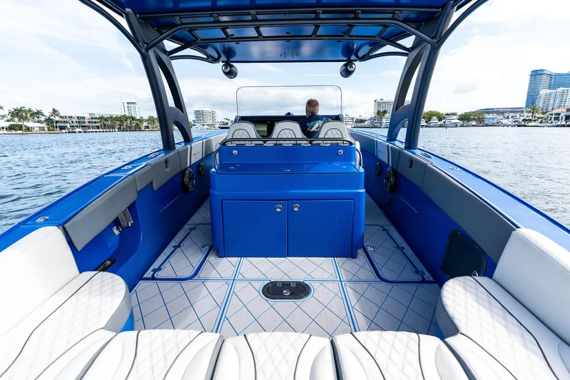  Yacht Photos Pics 2020 Midnight Express Open boat interior with blue and white seating on the water.