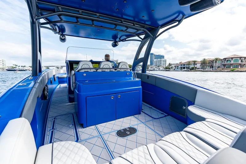  Yacht Photos Pics 2020 Midnight Express Open boat interior with blue and white seating, on a sunny day.