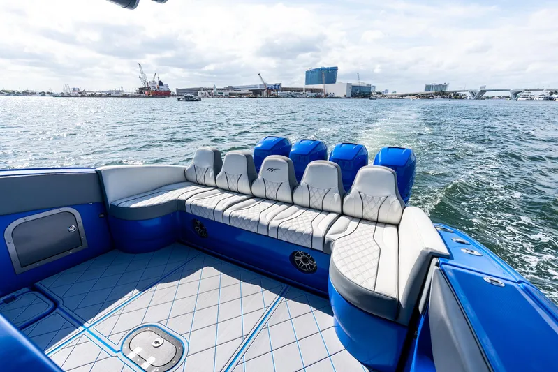 Yacht Photos Pics 2020 Midnight Express Open boat with blue and white seating, cruising on a sunny day.
