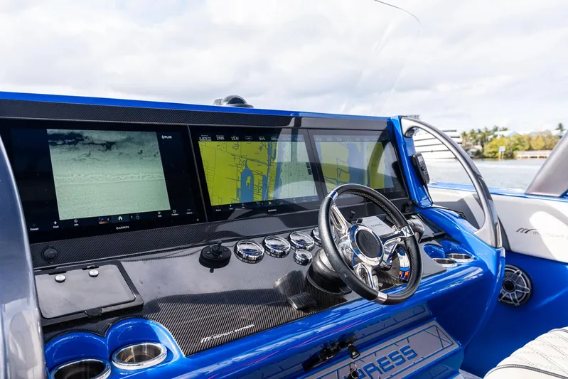  Yacht Photos Pics 2020 Midnight Express Open boat dashboard with navigation screens and steering wheel.