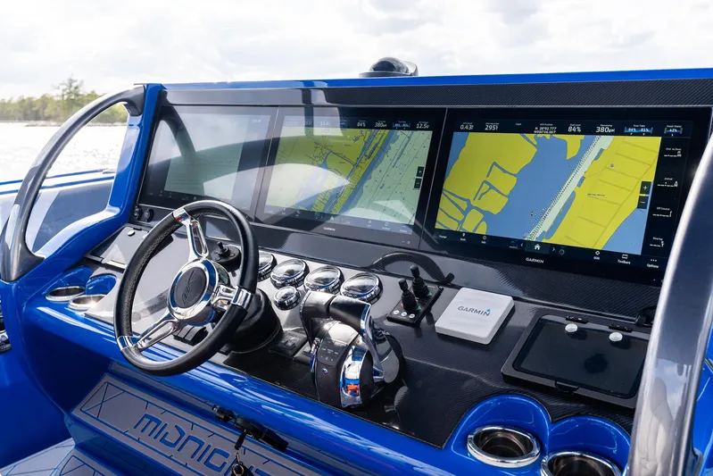  Yacht Photos Pics 2020 Midnight Express Open boat dashboard with navigation screens and steering wheel.