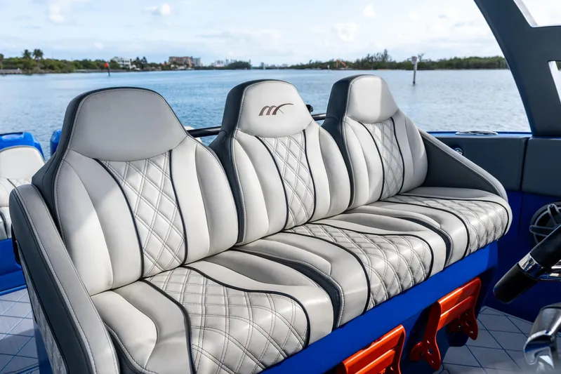  Yacht Photos Pics Luxurious seating on a 2020 Midnight Express Open boat, featuring elegant stitching and waterfront view.