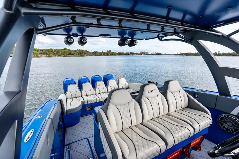  Yacht Photos Pics 2020 Midnight Express Open boat interior with luxurious seating on a calm water backdrop.