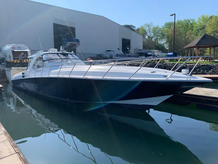  Yacht Photos Pics 2009 Fountain 48 Express Cruiser docked at marina, sleek design, calm water reflection.