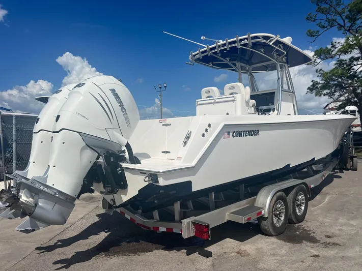  Yacht Photos Pics 2019 Contender 32 ST boat with dual Mercury engines on a trailer, under a clear blue sky.