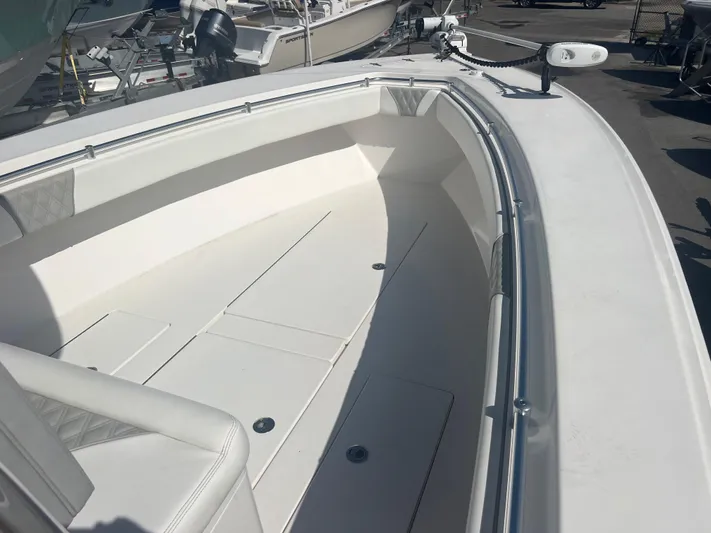  Yacht Photos Pics 2019 Contender 32 ST boat interior with white seating and deck, docked outdoors.