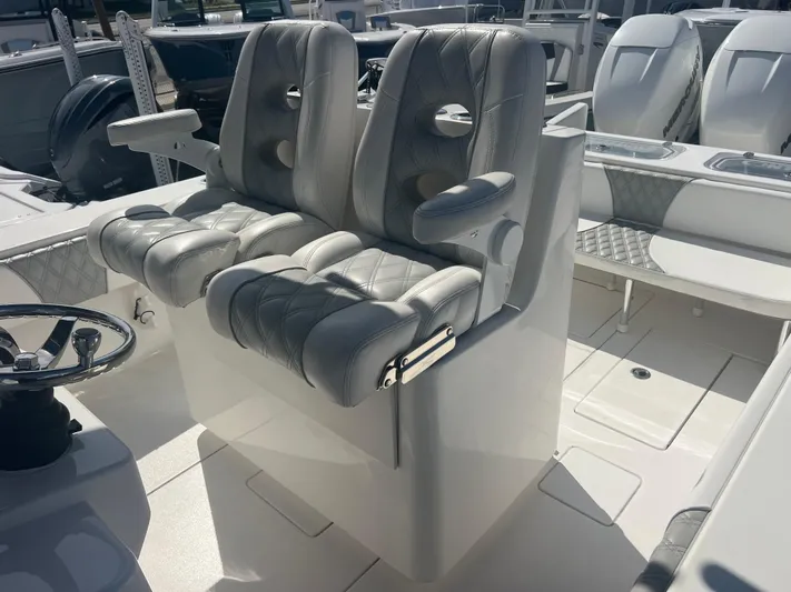  Yacht Photos Pics 2019 Contender 32 ST boat interior with dual cushioned seats and steering wheel.