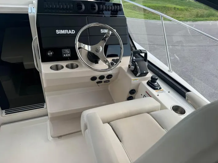  Yacht Photos Pics 2023 Boston Whaler 325 Conquest helm with Simrad electronics and comfortable seating.