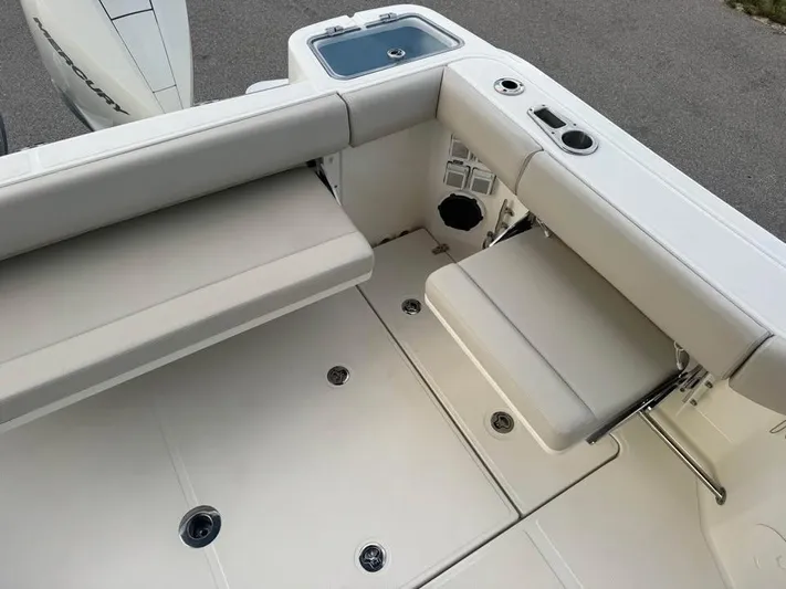  Yacht Photos Pics 2023 Boston Whaler 325 Conquest boat interior with seating and storage features.