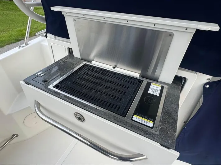  Yacht Photos Pics Outdoor grill on 2023 Boston Whaler 325 Conquest boat, featuring sleek design and stainless steel finish.